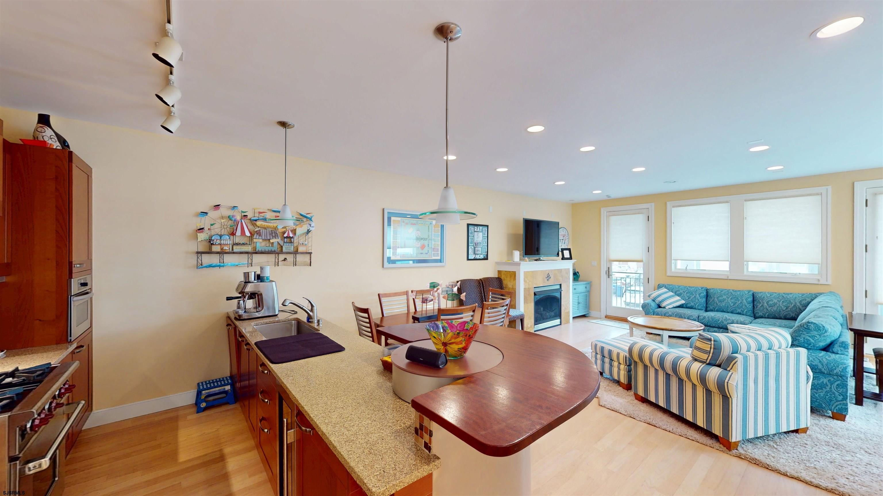 214 North Decatur Avenue, Unit 3B Margate City, NJ 08402 - Photo 10 of 41 a living room with furniture a flat screen tv and gym equipment