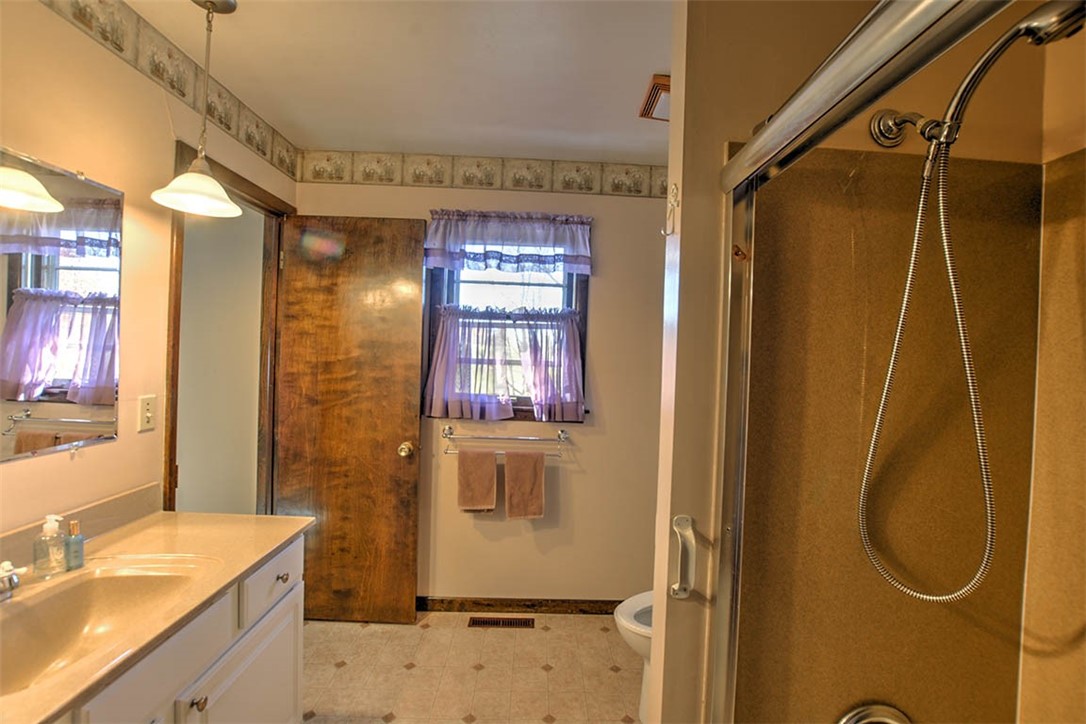3441 Ferris Drive Decatur, IL 62521 - Photo 18 of 30 a bathroom with a granite countertop shower a sink and a mirror