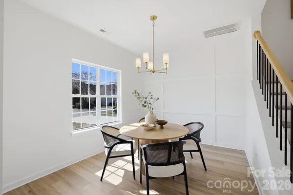 a view of a dining room with furniture window and wooden floor