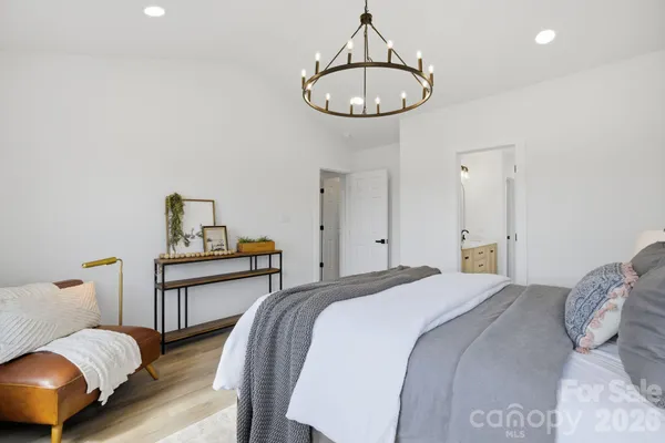 a bedroom with bed and wooden floor