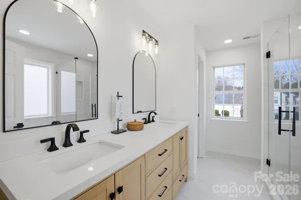 a bathroom with double vanity sink and a mirror