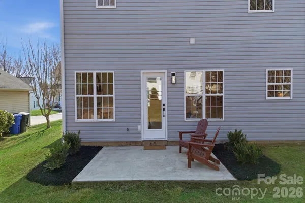 a view of house with backyard and outdoor seating
