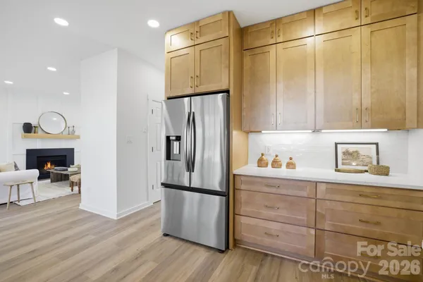 a kitchen with stainless steel appliances granite countertop a refrigerator and a stove top oven