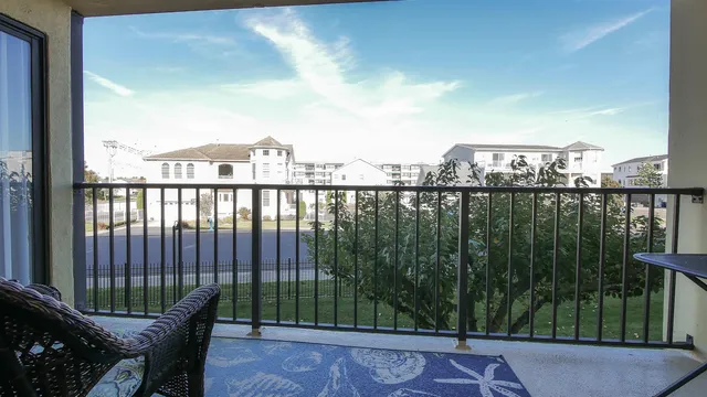 a view of a balcony with lake view and wooden floor