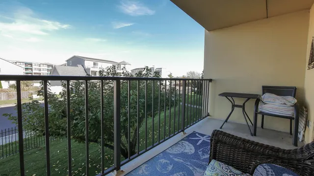a view of a balcony with furniture and city view