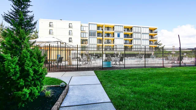 a front view of a building with a garden