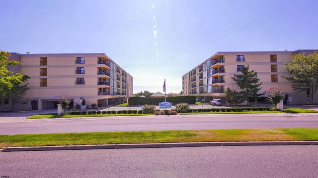 a view of a big building with big yard and large trees