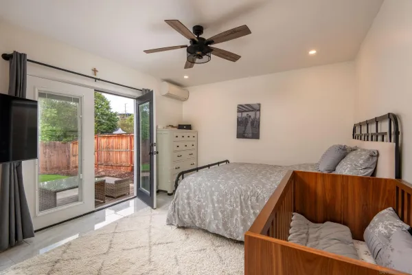 a bedroom with furniture and a large window