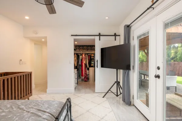 a living room with a flat screen tv and a walk in closet
