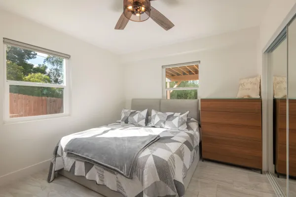 a bedroom with a bed and a window