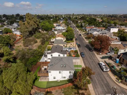 an aerial view of residential houses with outdoor space