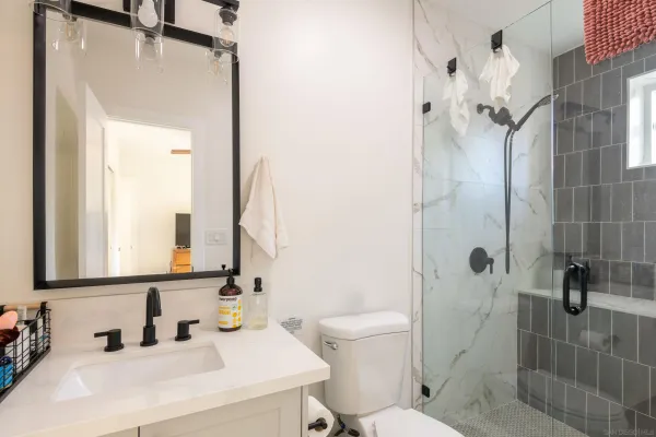 a bathroom with a sink toilet and shower