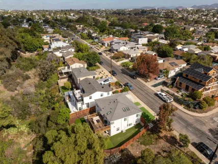 an aerial view of residential houses with outdoor space