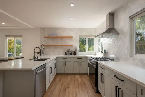 a kitchen with a sink stove and cabinets