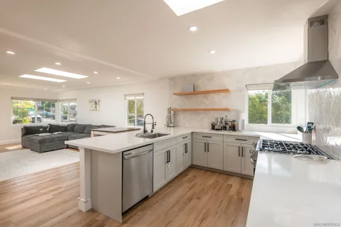 a kitchen with a sink stove and wooden cabinets