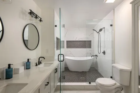 a bathroom with a toilet sink and mirror
