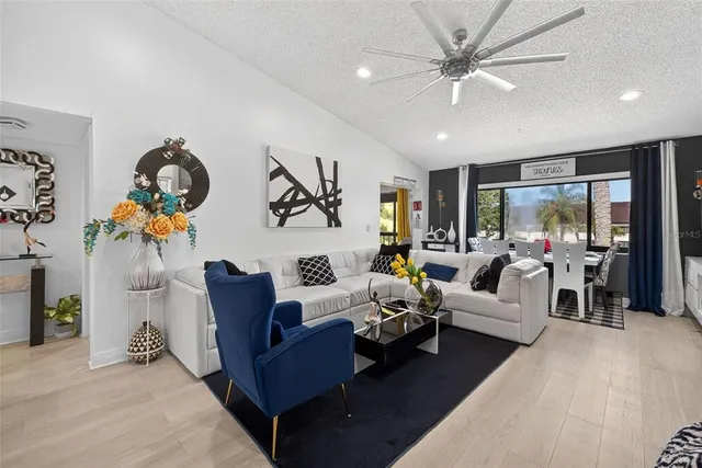 a living room with furniture and a chandelier