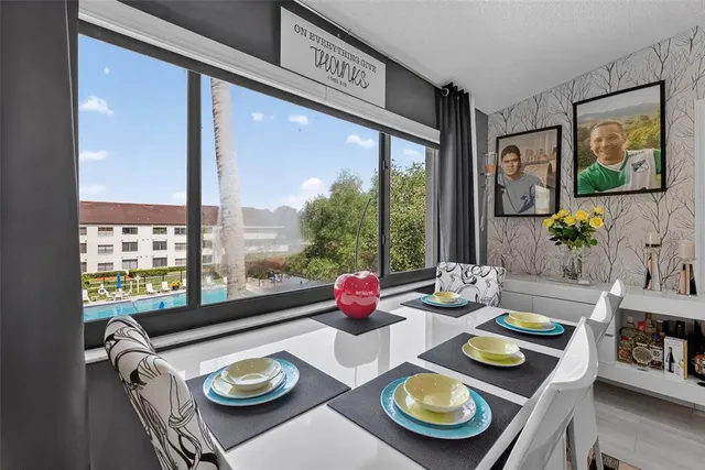 a kitchen with furniture and a large window