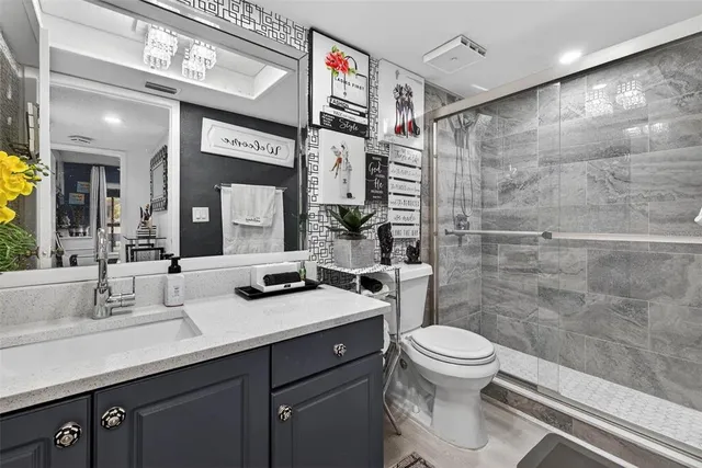 a bathroom with a sink a toilet and shower