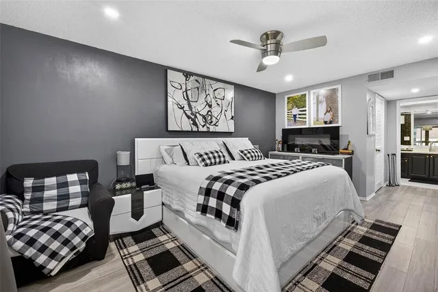 a bedroom with a bed and wooden floor