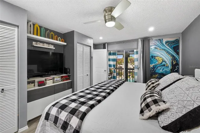 a bedroom with a bed and a flat screen tv