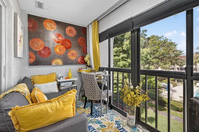 a blue couch sitting in front of a window with garden view