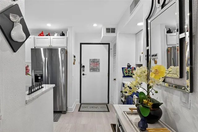 a kitchen with refrigerator and flowers