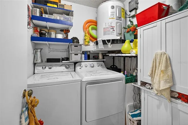 a view of a hallway with wooden floor and a bathroom