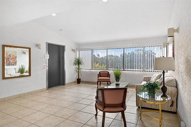 a view of a dining room with furniture floor to ceiling windows and tables