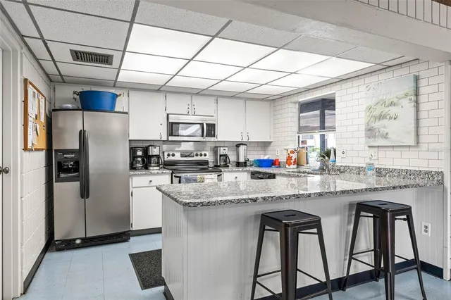 an aerial view of a house with a yard and outdoor seating