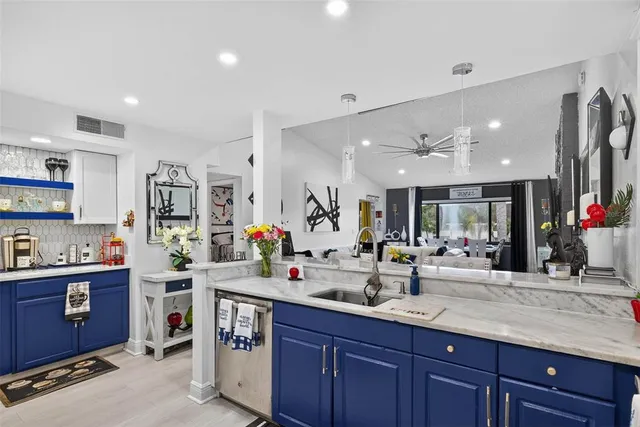 a kitchen with sink and cabinets