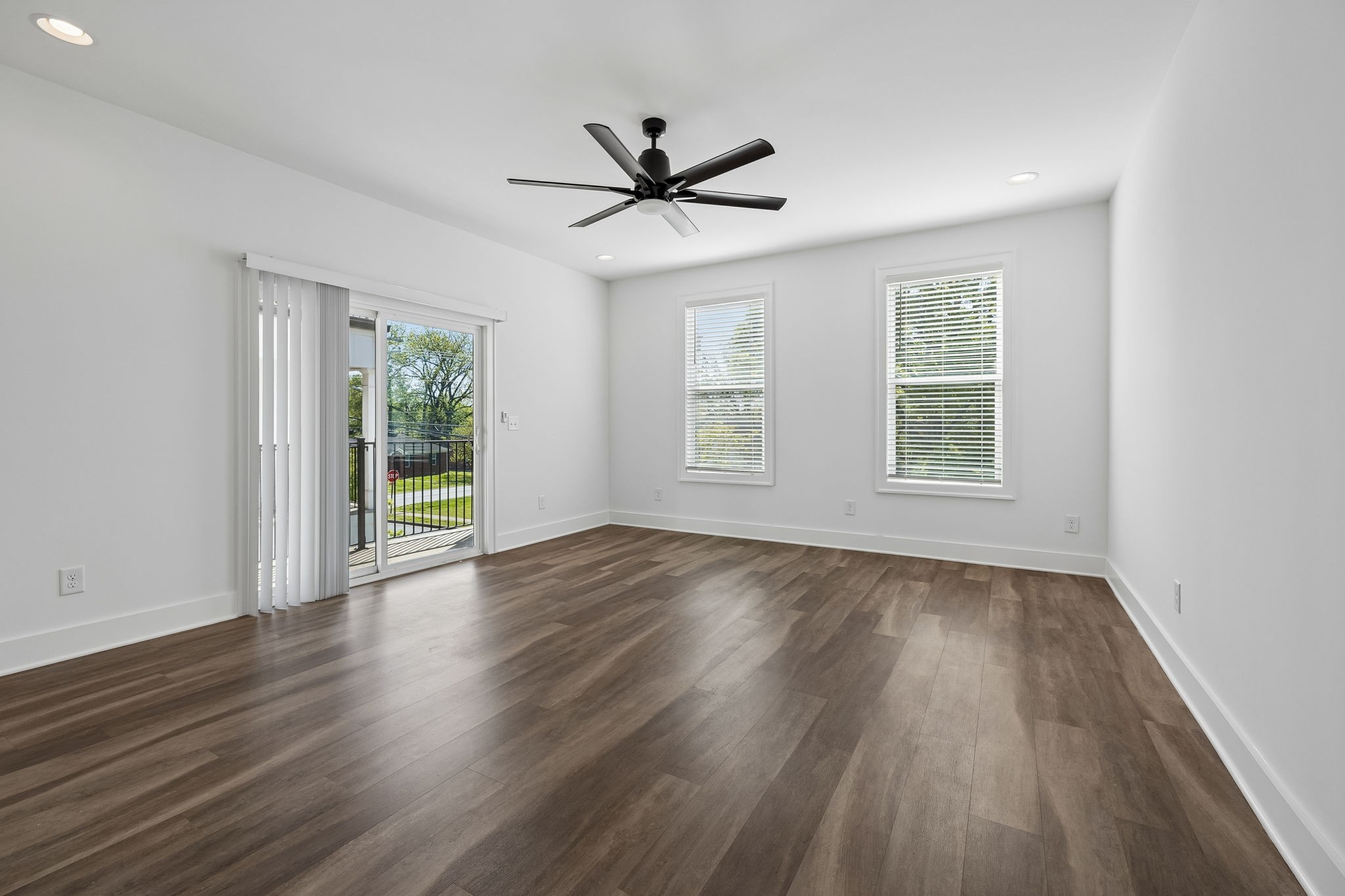 904 North Maple Street Murfreesboro, TN 37130 - Photo 13 of 34 an empty room with wooden floor a ceiling fan and windows