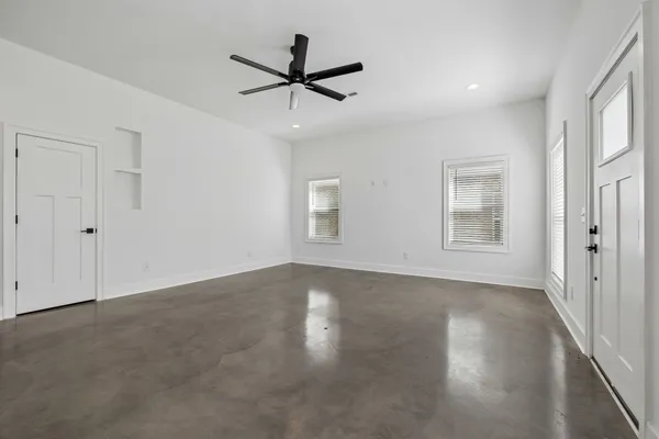 an empty room with closet and a bathroom