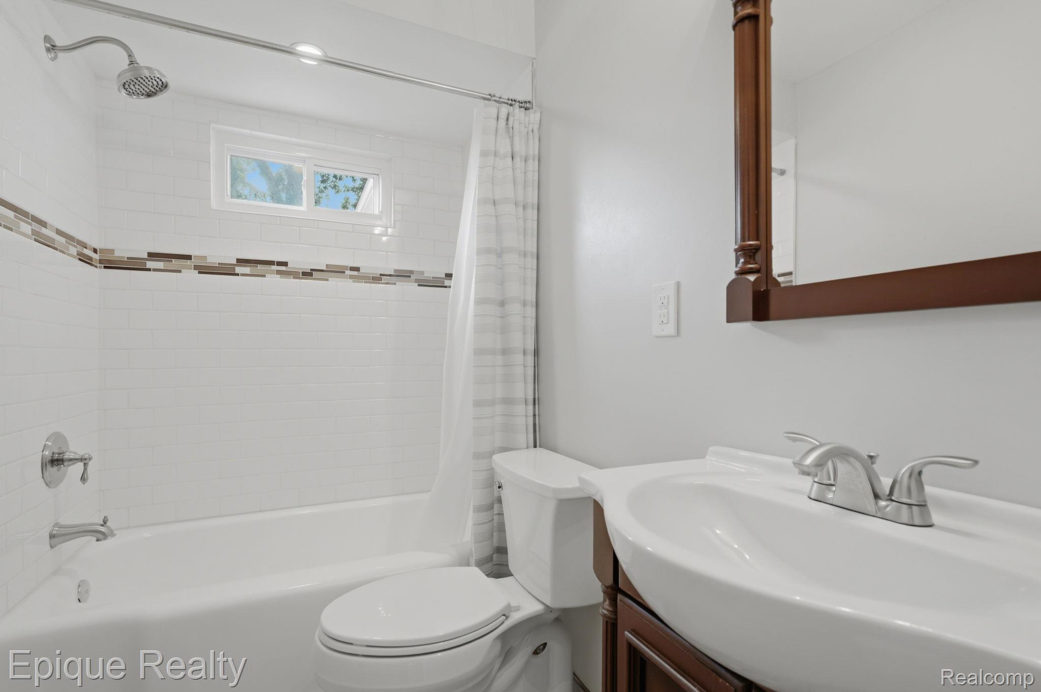 3402 Normandy Road Royal Oak, MI 48073 - Photo 21 of 32 Gorgeous full Bathroom featuring a white subway tile tub surround with an accent band, and window for natural light