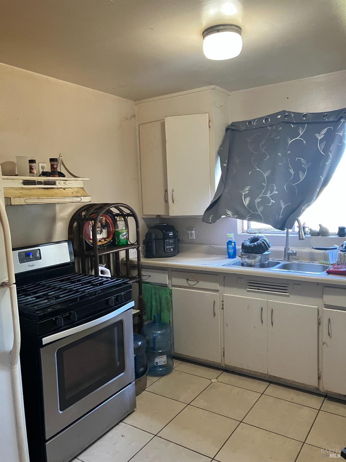 1605 Hearn Avenue Santa Rosa, CA 95407 - Photo 4 of 6 a kitchen with granite countertop a stove and a sink