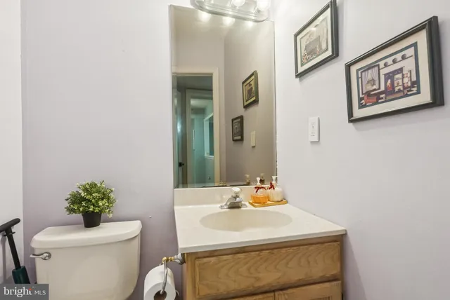 a bathroom with a sink toilet and a mirror