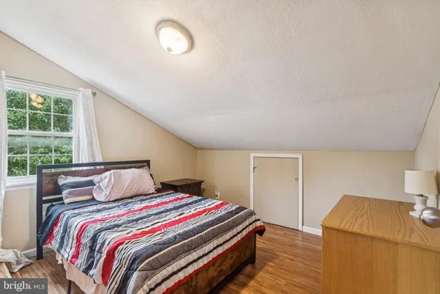 a bedroom with a bed and window