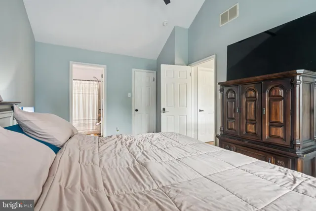 a bedroom with a bed and a large window