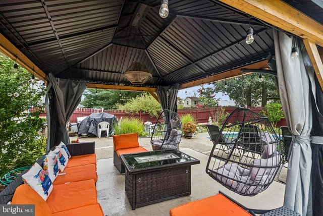 an outdoor sitting area with furniture and garden view