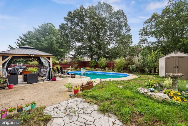 a view of a backyard with swimming pool