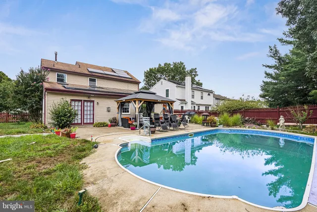 a view of a house with swimming pool and sitting area