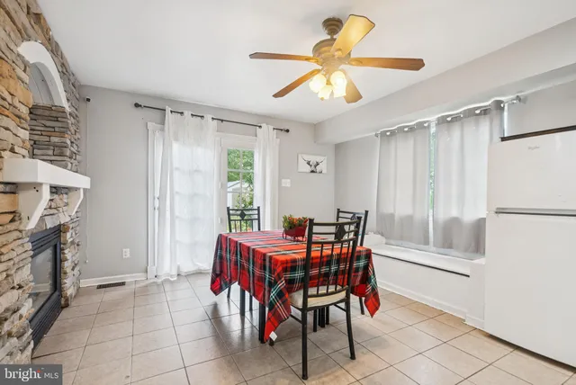 a dining room with furniture and a chandelier