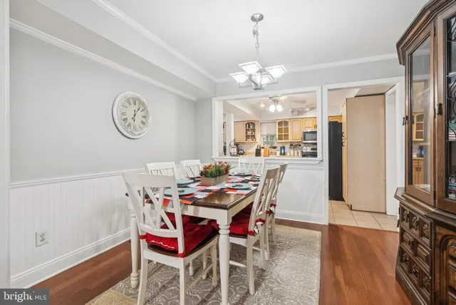 a view of a dining room with furniture wooden floor and a chandelier