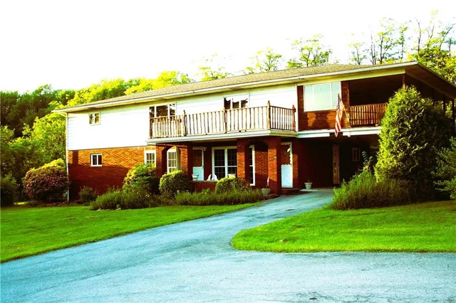 a view of a house with a yard and plants