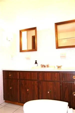 a bathroom with a sink a toilet and mirror