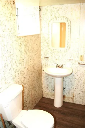 a bathroom with a toilet a sink and a shower