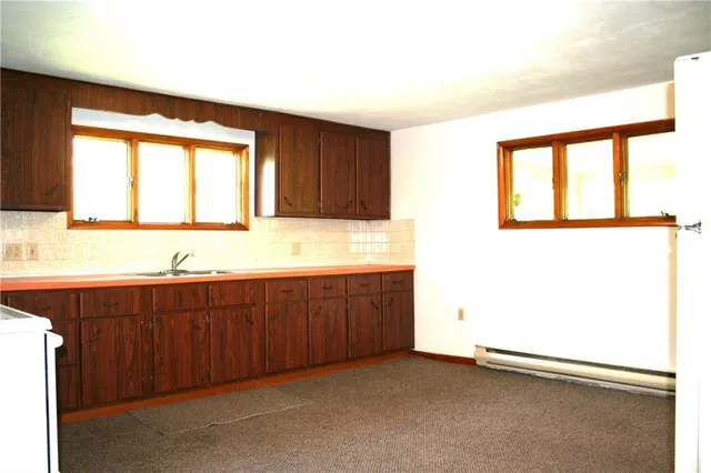 a bathroom with a toilet a sink and a shower