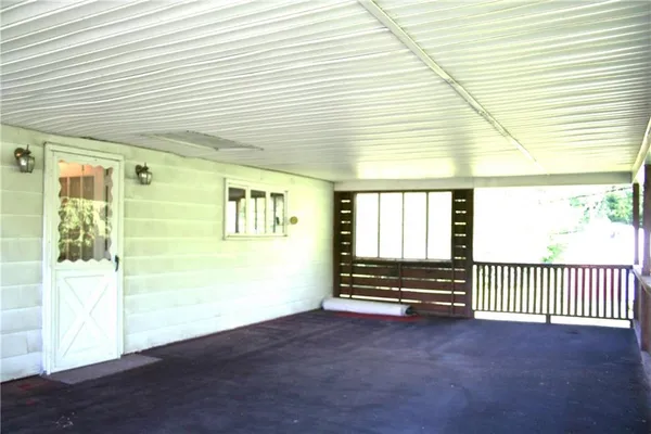 a view of a glass door with wooden floor and a window