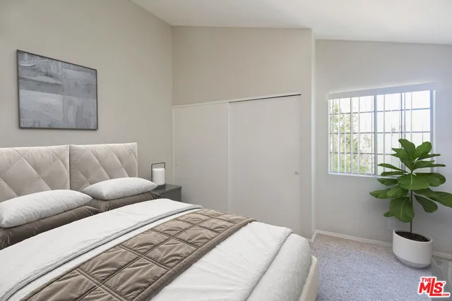 a bedroom with furniture and a potted plant