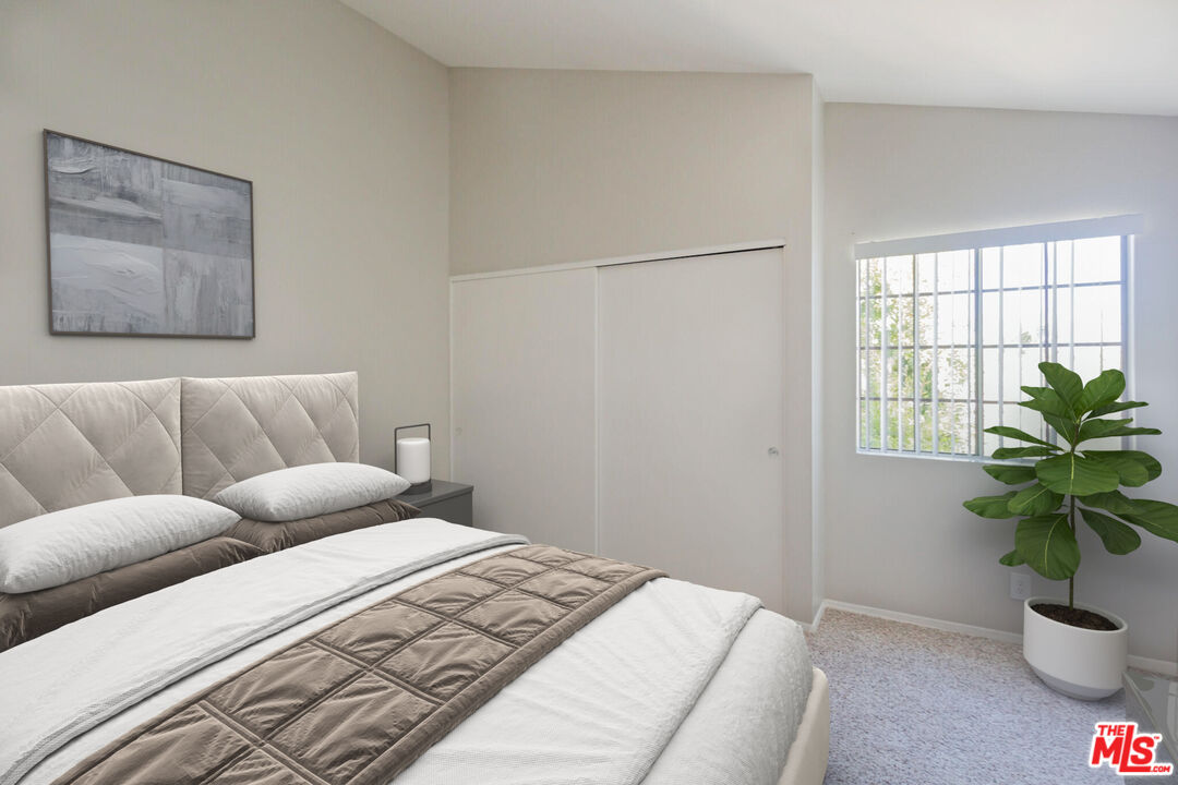 7342 Haskell Avenue Van Nuys, CA 91406 - Photo 4 of 10 a bedroom with furniture and a potted plant